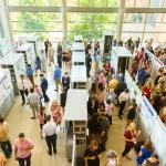 an overhead shot of a large crowd viewing research posters in the CSI cube